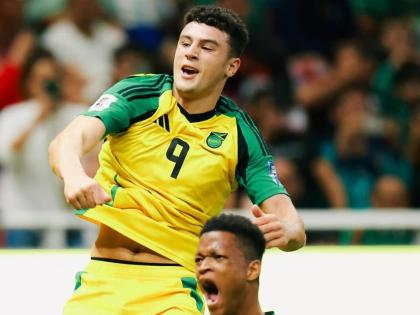 Reggae Boyz players Bailey Cadamarteri (left) and Richard King celebrate the former’s 18th-minute goal during a FIFA playoff game against New Caledonia at the Guadalajara Stadium last week.