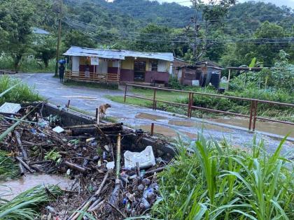 Debris block the waterway at this bridge along the Seaview Farm Road in Portland on Saturday. The blockage resulted in the river overflowing its banks, sending water into nearby homes.