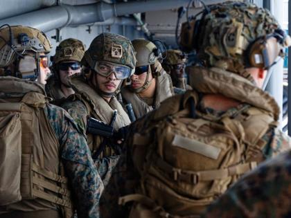 This image from video provided by United States Central Command shows US Sailors and Marines aboard USS Tripoli (LHA 7) arriving in the U.S. Central Command area of responsibility on March 27, 2026. (US Central Command via AP)