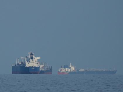 Oil tankers and cargo ships line up in the Strait of Hormuz, as seen from Khor Fakkan, United Arab Emirates.
