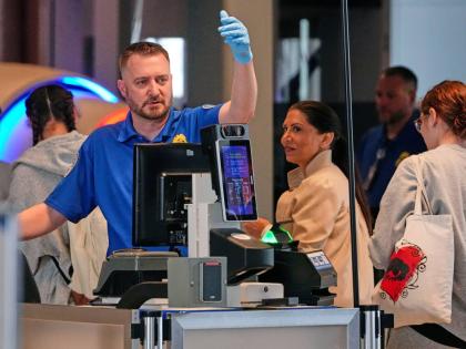 A TSA agent checks passengers at the security checkpoint in Pittsburgh International Airport Monday, March 30, 2026. (AP Photo/Gene J. Puskar)