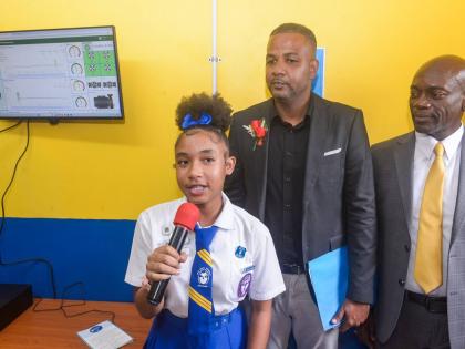 Student at José Martí Technical High School in St Catherine, Teandra Williams (left), explains features of the state-of-the-art smart greenhouse, gifted to the school by the Ministry of Education, Skills, Youth and Information. Others pictured are Senior