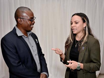 Gabrielle Gilpin-Hudson, president of the Realtors Association of Jamaica, in conversation with Gregory Bennett, deputy CEO, Spatial Planning Division, National Environment and Planning Agency, during the RAJ Green Sustainability event held recently at the
