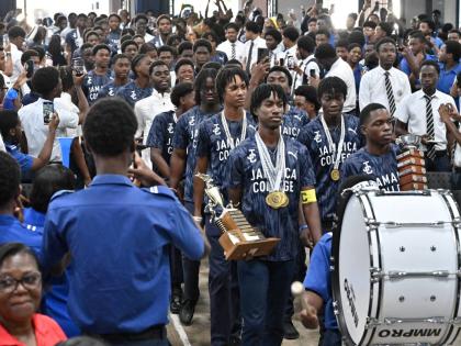 With hair of varying styles and lengths, Jamaica College students celebrating their victory in the ISSA/GraceKennedy Boys’ Athletics Championships last month.