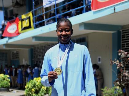 Brittany Baron of Edwin Allen High School is celebrated for her outstanding performance during a ceremony at the school yesterday.