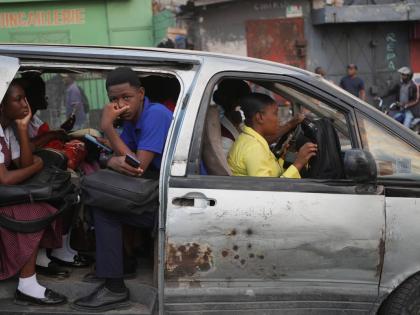 Passengers ride in a shared taxi as it makes its way through Port-au-Prince, Haiti, Wednesday, March 25, 2026. (AP Photo/Odelyn Joseph)