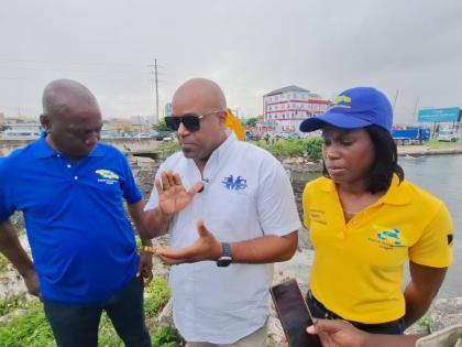 Dwight Crawford (centre), deputy mayor of Montego Bay, stresses the importance of keeping the South Gully clear to prevent flooding while Audley Gordon (left), executive director of the National Solid Waste Management Authority, and Shenique Johnson, deput