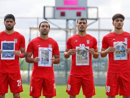 Iran’s players sing the national anthem, holding pictures of children allegedly killed in US and Israel strikes in Iran, before a friendly football match against Costa Rica, in Antalya, southern Turkey, yesterday.