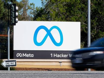 A car passes Facebook's new Meta logo on a sign at the company headquarters on October 28, 2021, in Menlo Park, Calif. (AP Photo/Tony Avelar, File)