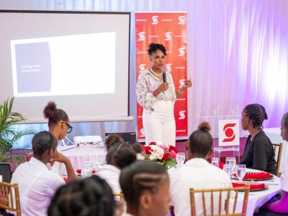 Ashley-Rae Barrett, customer service officer at Scotiabank, takes students through the basics of budgeting during the Scotia Foundation’s International Women’s Day Luncheon on March 20.