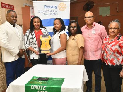 President, Rotary Club of Trafalgar New Heights, Franchesca Francis (second left), presents an Automated External Defibrillator (AED) to Medical Officer, Duhaney Park Health Centre, Dr Wendy-Ann Byfield-Lyons (third left), at the health facility in St An