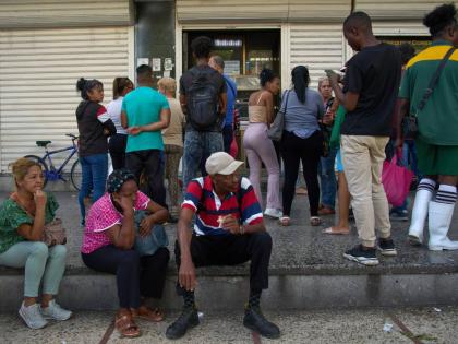 People wait their turn to enter a bank in Havana, Cuba, Wednesday, April 1, 2026. (AP Photo/Ramon Espinosa)