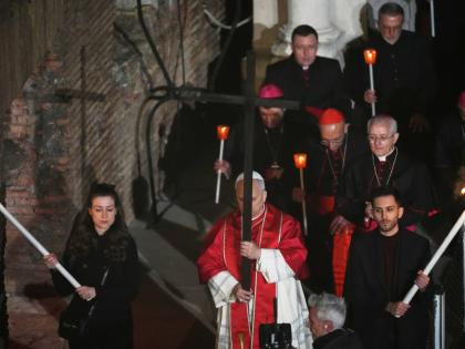 Pope Leo XIV carries a lightweight, 1.5-meter (5-foot) wooden cross during the Via Crucis, the torchlit Good Friday Stations of the Cross procession at the Colosseum in Rome, which symbolically retraces Jesus Christ’s steps to his crucifixion on Calvary 