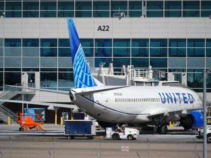 A United Airlines jetliner sits at a gate along the A concourse of Denver International Airport, March 20, 2026, in Denver. (AP Photo/David Zalubowski, File)