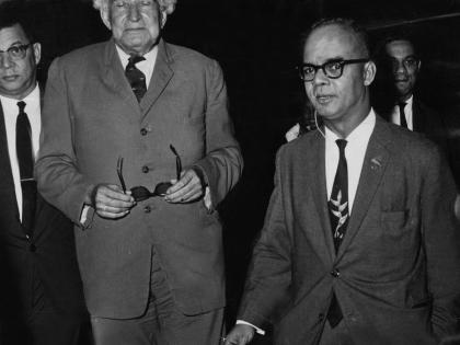 Sir Alexander Bustamante (centre), prime minister of Jamaica, is seen at Piarco Airport terminal building with Eric Williams (right), prime minister of Trinidad and Tobago. In the background are Donald Sangster (left) and Arthur Brown .  