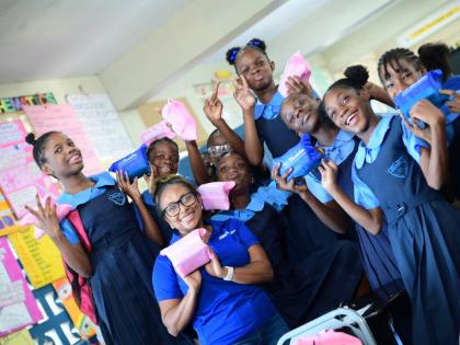 Samara South, a member of the JWN Foundation, takes some time to share in this picture moment with girls from Balmagie Primary School.
