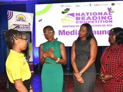 State Minister, Ministry of Education, Skills, Youth and Information,  Rhoda Moy Crawford (second right), listens as CEO of VM Foundation, Samantha Charles (second left), makes a point to Jamaica Library Service (JLS) National Reading Competition 2025 winn