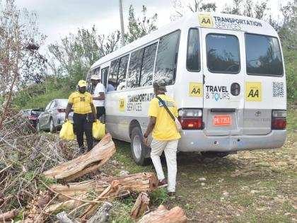 Ramon Smith, a JN volunteer, carries relief packages for residents of Harmony Hall. The JN Foundation with funding from Corus International, an ensemble of faith-based organisations, organised a mission to the community to provide residents, slowly recover