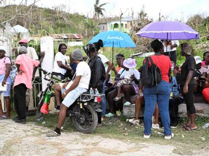 Residents gather to get food at the World Central Kitchen location in Beeston Spring, Westmoreland, during the first month after Hurricane Melissa made landfall in Jamaica last October. 