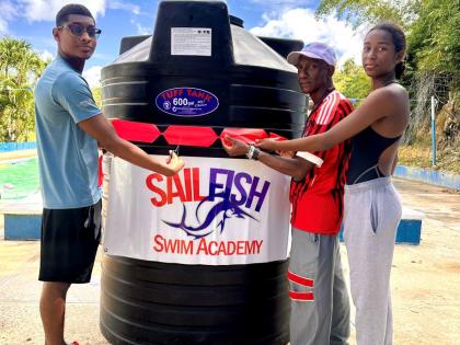 From left:  Suraj Guwalani, coach Eric Raul Urdaneta, and Shreya Guwalani during a ribbon-cutting ceremony for the presentation of a 600-gallon  tank to the SailFish Swim Academy in Tucker, St James, on Saturday, March 28.