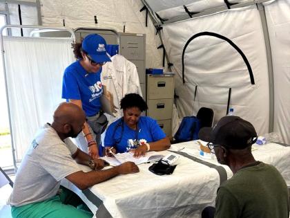 Dr Dahlia Blake, Dr Brandon Davis, and Dionne Blackwood discussing a patient’s case. 