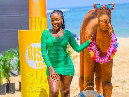 Entrepreneur Segaine Reid stands out in green beach-chic attire.