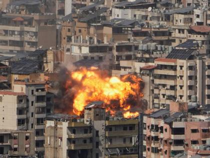 Flames rise from an Israeli airstrike in Beirut suburbs in Lebanon on March 11, 2026. (AP Photo/Hassan Ammar)
