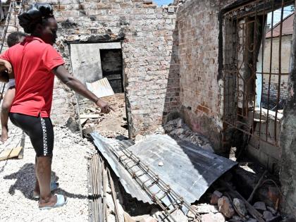 Kimonia Thomas hold her young daughter as she explains the impact of the devastating March 9 fire that left them homeless.