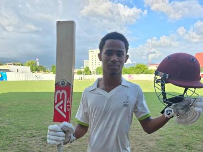 St Elizabeth Technical High School middle-order batsman, Ryan Lyttleton celebrates scoring a hundred during the ISSA/First Global Bank/GK Spaulding Cup final at the Melbourne Oval yesterday.