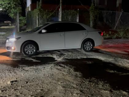 A motorist struggling to navigate the terrible road conditions in Strathbogie.