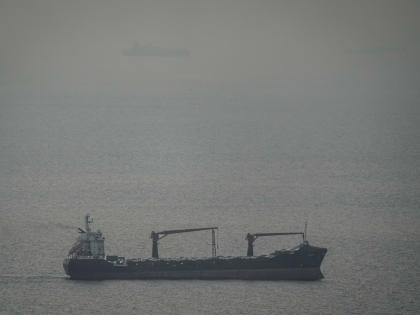 A cargo ship carrying vehicles sails through the Arabian Gulf toward the Strait of Hormuz in the United Arab Emirates.