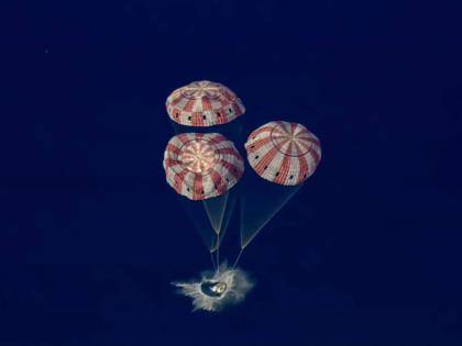 In this image from video provided by NASA, the Artemis II Orion capsule splashes down in the Pacific Ocean, on April 10, 2026. (NASA via AP)