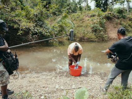 Directors Delroy Johnson and Gabrielle Blackwood (right) film Sanicka Scott from Hanover for ‘The Forgotten Daughters’, a short documentary on the experiences of women and children affected by Hurricane Melissa. The film is part of Behind Her Lens: Wom