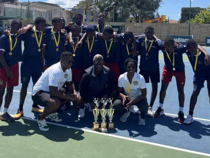 Members of the Munro College tennis team with (in front, from left)  manager Kirk Radway, coach Andre Brown and assistant coach Suan Reid. 