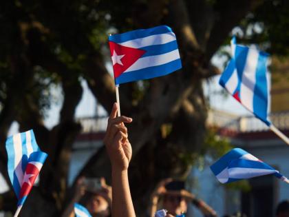 Women wave Cuban flags during a rally calling for the end of the U.S. blockade against the island nation in Havana, Cuba on April 7, 2026. (AP Photo/Ramon Espinosa)