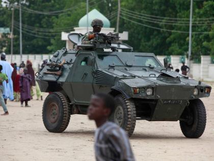 Nigerian soldiers ride on an armored personnel carrier during Eid al-Fitr celebrations in Maiduguri, in Borno state, Nigeria om August 8, 2013. (AP Photo/Sunday Alamba, File)