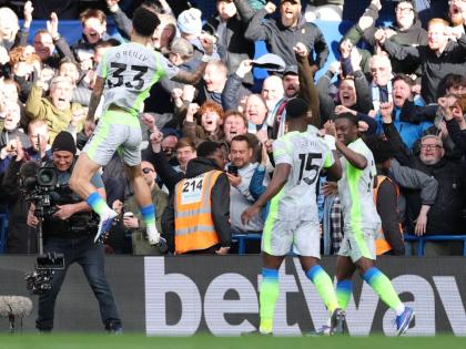 Manchester City's Nico O'Reilly celebrates after scoring during the Premier League football match between Chelsea and Manchester City in London on April 12, 2026. (AP Photo/Ian Walton)