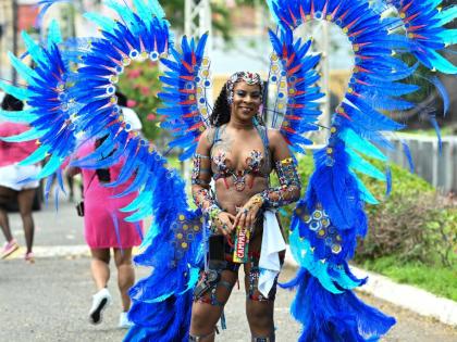 Tiffany Hill of the Xodus OlympiX band takes part in Carnival road march in St Andrew on April 12, 2026. 
