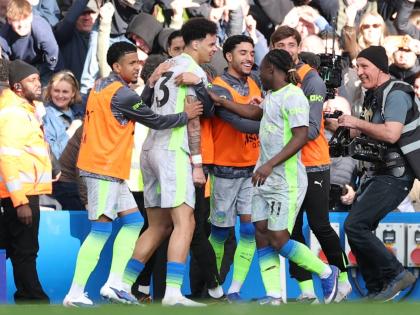 Manchester City players celebrate after a goal by Nico O’Reilly (centre) during the English Premier League  match against Chelsea in London, England, yesterday.