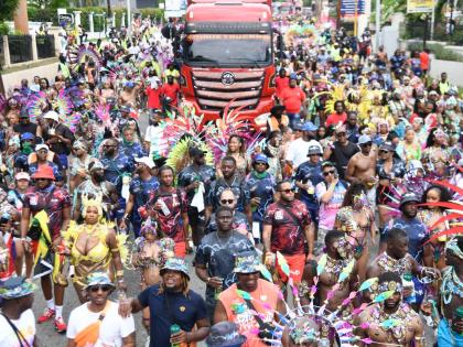 Gen XS masquerades pause their revelery as they make their way down Hope Road in St Andrew pass the Andrews Memorial Hospital on Carnival Sunday. Kibwe McGann, a director of the band, said foreigners returned in their numbers, and the local participation m