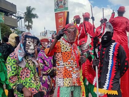 Members of the Kayah Junkunno band mix and mingle with Yard Mas revellers during Sunday’s road march.