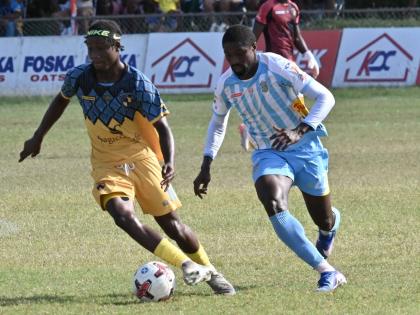 Colorado Murray (right) of Waterhouse and Racing United’s Nickyle Ellis battle for the ball during yesterday’s Jamaica Premier League match at Ferdi Neita Park. Waterhouse won 1-0.