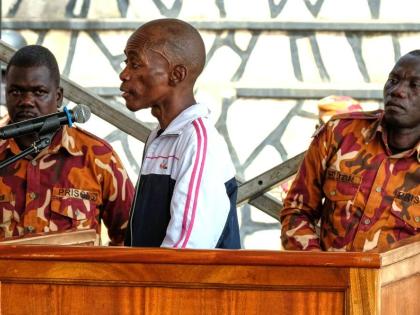 Christopher Okello Onyum, a man accused of killing four children, appears in court at the Ggaba Community Church grounds, in Kampala, Uganda, Monday, April 13, 2026. (AP Photo/Hajarah Nalwadda) 