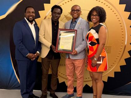 Jamaica‑born visual artist Andy Ballentine (second left) poses with his official proclamation alongside Miramar Vice Mayor Eddy Edwards (second right), Commissioners Maxwell B. Chambers (left) and Avril Cherasard last Friday. 