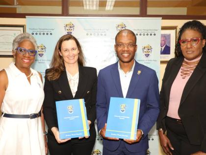 From left: Sandra Glasgow, managing director of RevUp Caribbean Limited; Melanie Subratie, chairman of FirstAngels Caribbean Limited; Dr Kevin Brown, president of the University of Technology, Jamaica (both holding folders containing signed copies of the a