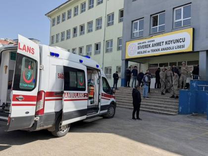 Turkish security forces and emergency staff stand at the courtyard of a high school where an assailant opened fire, in Siverek, south east Turkey, Tuesday, April 14, 2026, (Mevlut Bayraktar/IHA via AP)