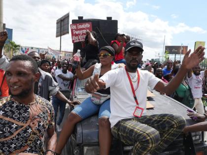 Factory workers march to demand a salary increase in Port-au-Prince, Haiti, Monday, April 13, 2026. (AP Photo/Odelyn Joseph)
