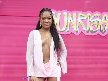 Nicolette Holness, a human resources professional from Toronto, poses in a plunging neckline mini, paired with matching heels and handbag.