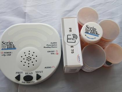 The ScripTalk device and medication containers with the Radio Frequency Identification (RFID) technology tags. The assistive technology reads prescription information aloud, helping persons who are blind, visually impaired, or have reading challenges manag