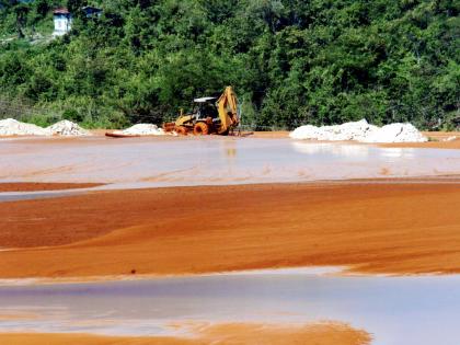 A tractor uses marl to raise the height of the bank at the red mud lake in Manchester, belonging to West Indies Alumina Company (WINDALCO). (Norman Grindley)